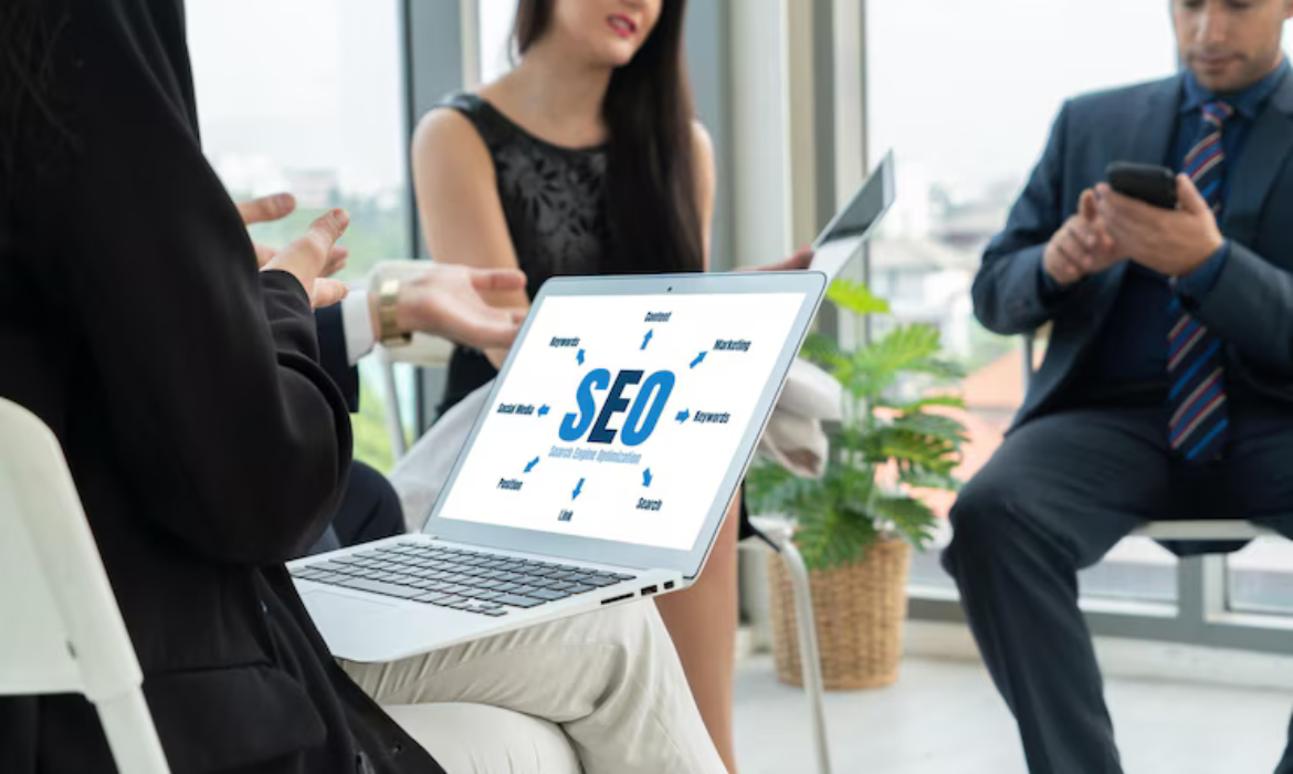 Business professionals discussing SEO Services along with strategies in UAE with a laptop displaying SEO-related terms.