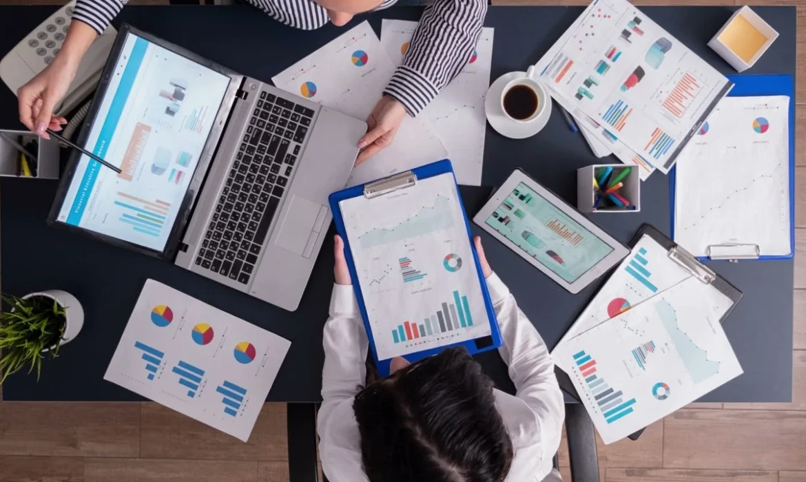 Team at Dubai Marketing Agency analyzing marketing reports, charts, and KPIs during a strategy meeting.