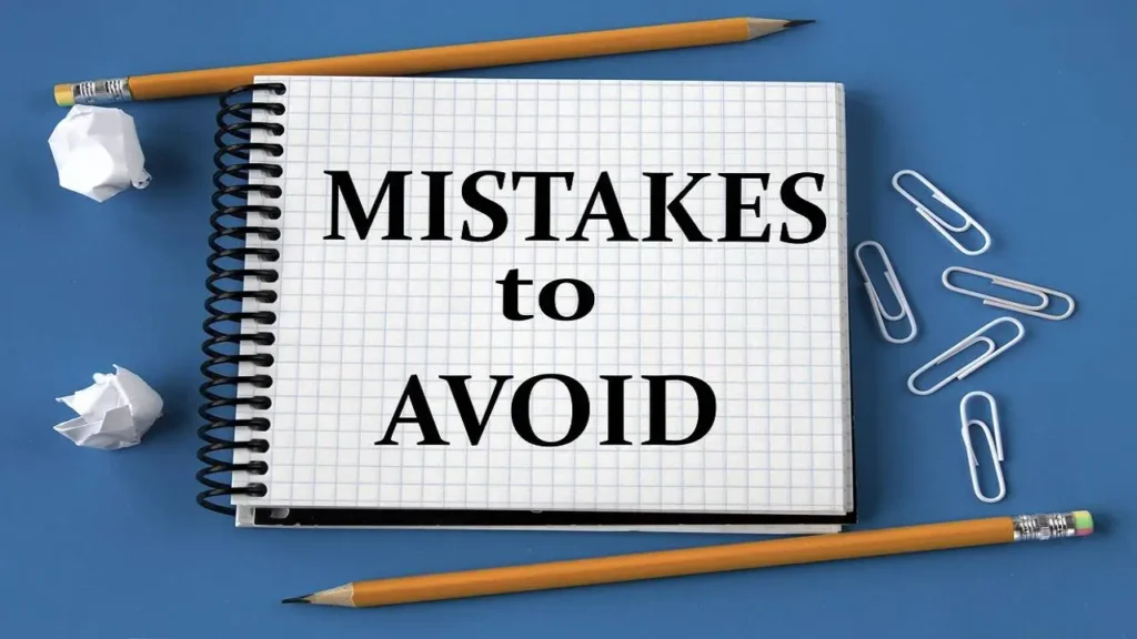 Notebook with the words "Mistakes to Avoid" surrounded by pencils and paperclips, highlighting planning errors in Online Marketing in Dubai.