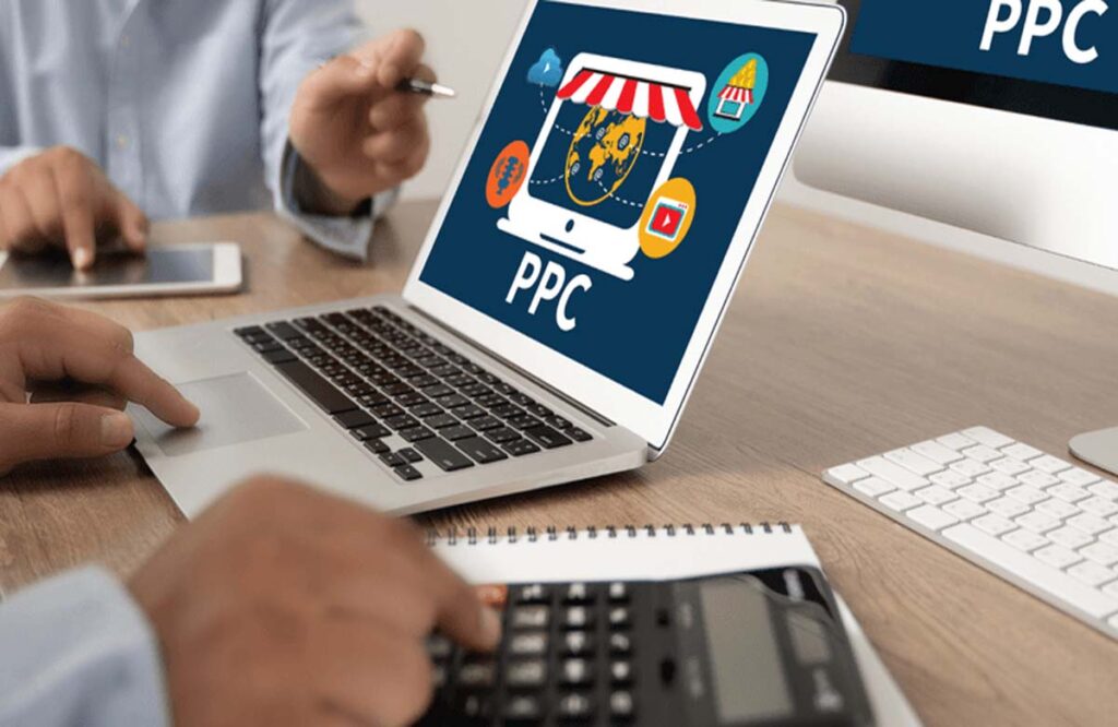 PPC account management in Dubai team analyzing data on a laptop with digital advertising visuals.