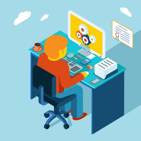 Person working on computer with gears on screen in an office setting.